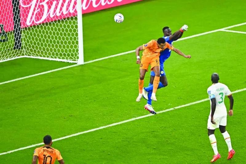 TOPSHOT - Netherlands' forward #08 Cody Gakpo (C) scores his team's first goal as Senegal's goalkeeper #16 Edouard Mendy (2nd R) fails to stop it during the Qatar 2022 World Cup Group A football match between Senegal and the Netherlands at the Al-Thumama Stadium in Doha on November 21, 2022. (Photo by MANAN VATSYAYANA / AFP)