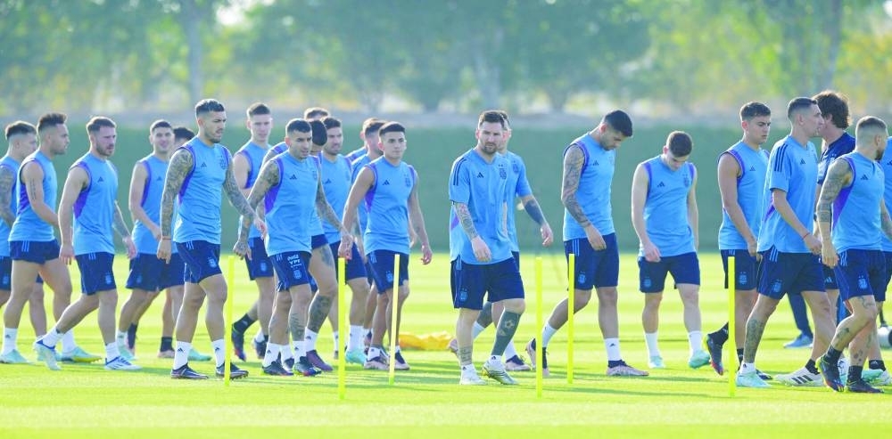 Argentina’s forward Lionel Messi (centre) and teammates take part in a training session at the Qatar University Training Site on Monday. (AFP)