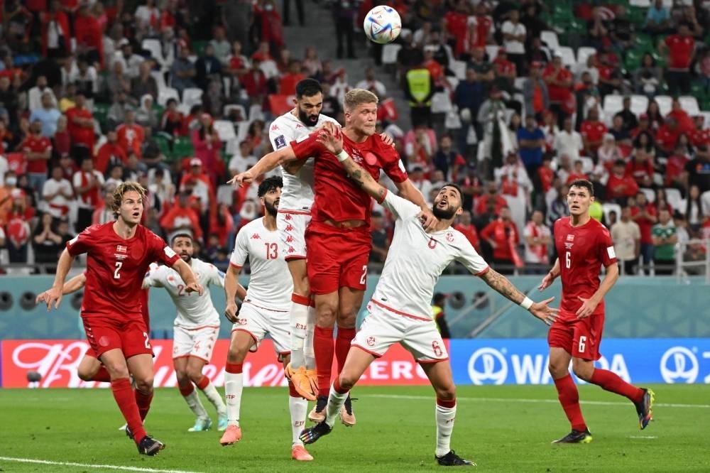  Denmark&#039;s forward #21 Andreas Cornelius heads the ball during the Qatar 2022 World Cup Group D football match between Denmark and Tunisia at the Education City Stadium in Al-Rayyan. AFP