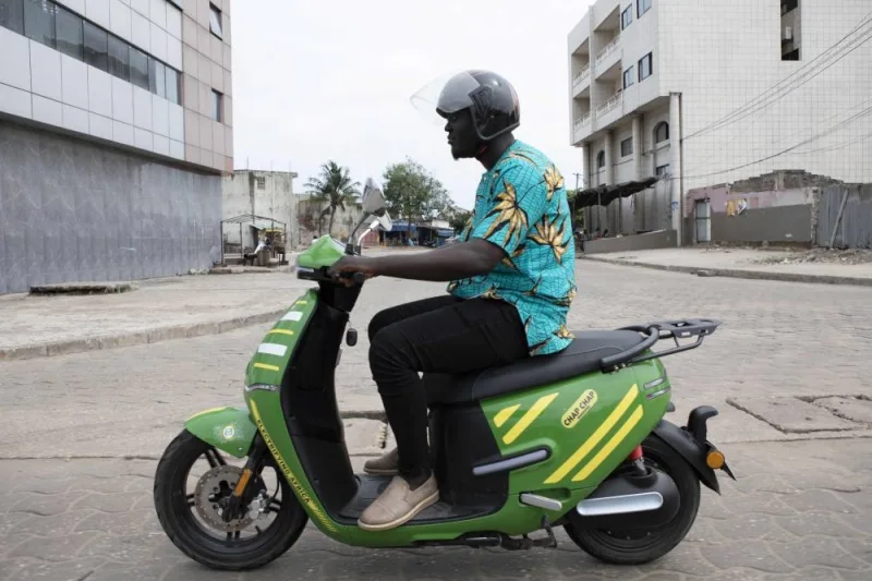A man rides his electric motorcycle on the roads of Cotonou. (AFP)
