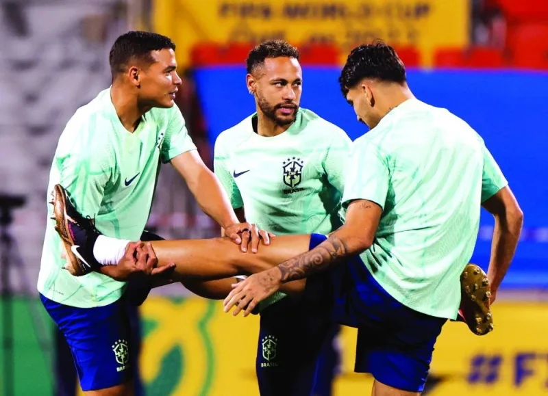 Brazil’s Neymar (centre), Lucas Paqueta and Thiago Silva (left) during a training session at the Al Arabi Stadium in Doha yesterday. (Reuters)