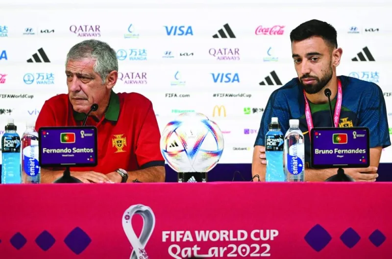 Portugal's coach Fernando Santos (left) and Portugal's midfielder Bruno Fernandes hold a press conference at the Qatar National Convention Centre (QNCC) in Doha, yesterday.