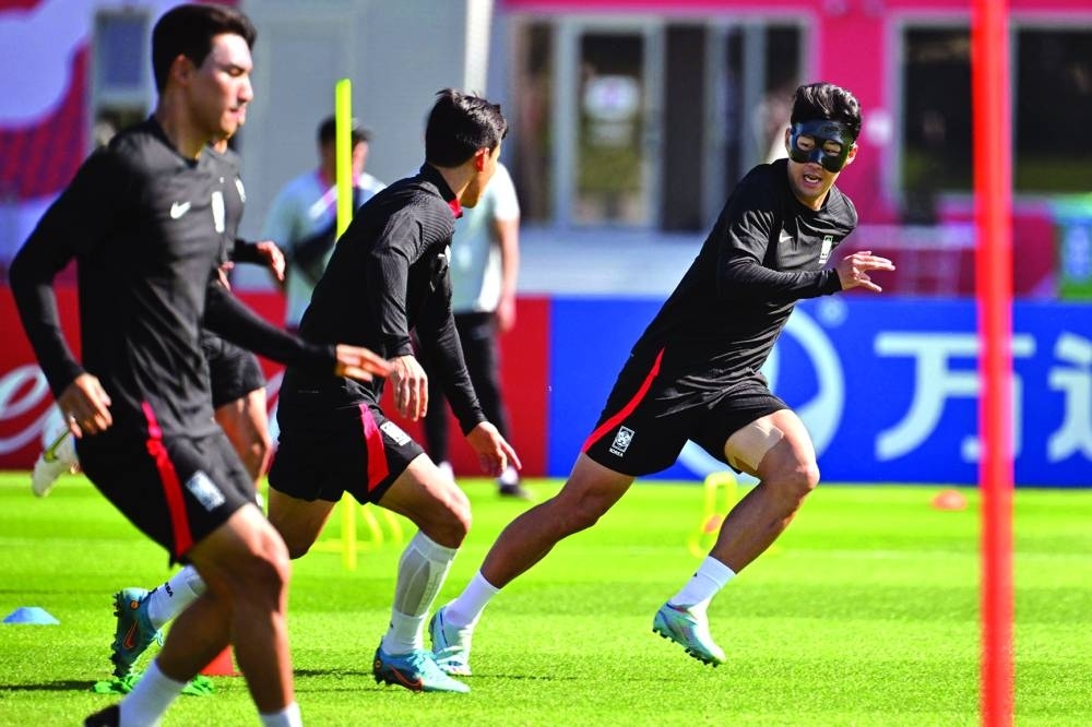 South Korea’s midfielder Son Heung-min (right) takes part in a training session with teammates at the Al Egla Training Facility in Doha yesterday, on the eve of the World Cup Group H match against Uruguay. (AFP)