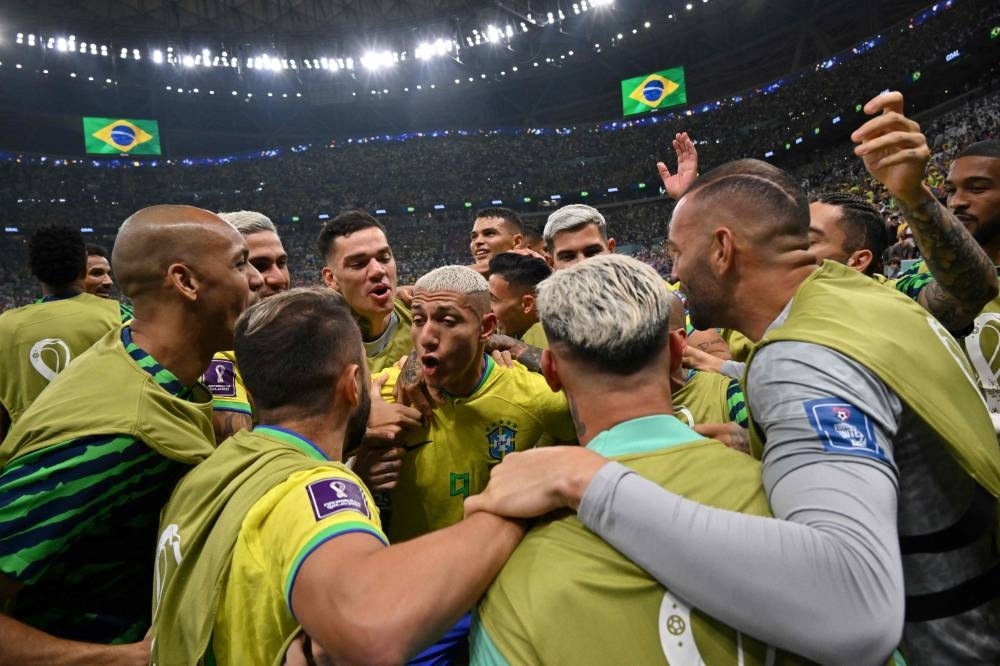 Brazil’s forward Richarlison (centre) celebrates with teammates after scoring against Serbia during the World Cup Group G match at the Lusail Stadium yesterday.  (AFP)
