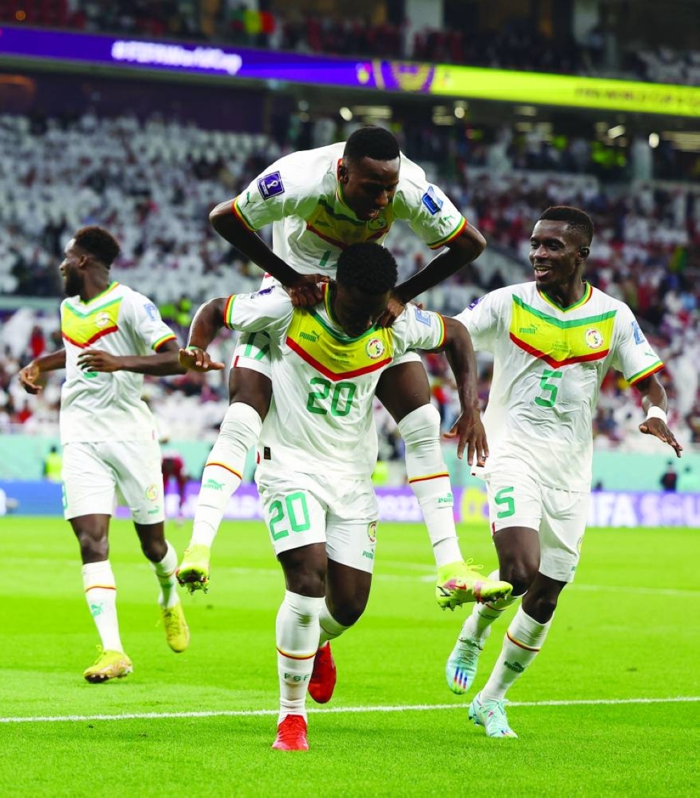 Senegal’s Bamba Dieng celebrates scoring with teammates Pape Matar Sarr and Idrissa Gana Gueye. (Reuters)