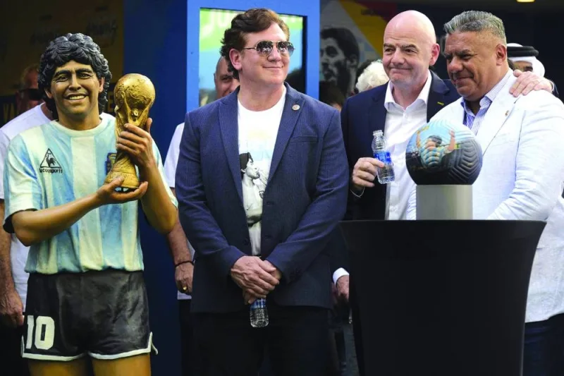 FIFA President Gianni Infantino, CONMEBOL’s President Alejandro Dominguez and AFA’s President Claudio Tapia gesture during a tribute ceremony to late football legend Diego Maradona on the 2nd anniversary of his death at CONMEBOL fan zone “Tree of dreams” during the Qatar 2022 World Cup in Doha yesterday. (AFP)