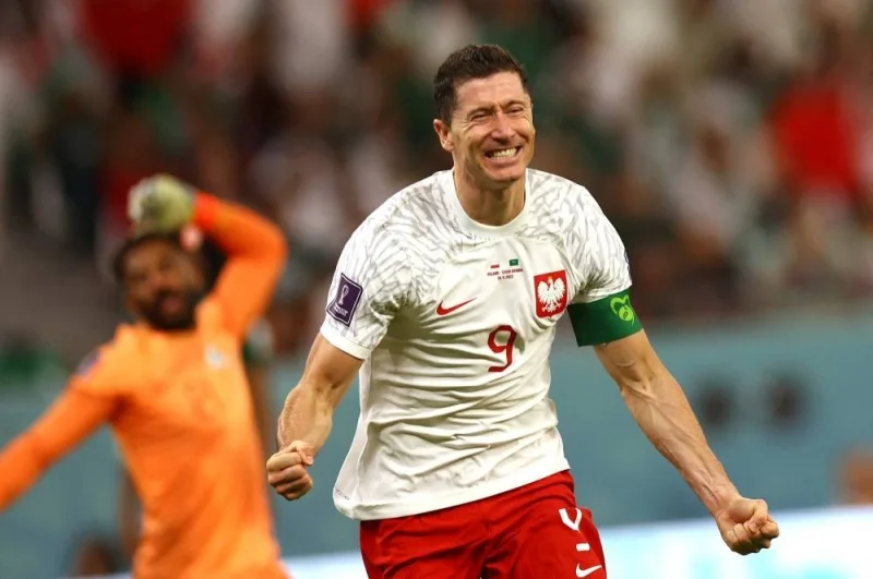 Poland&#039;s Robert Lewandowski celebrates scoring their second goal as Saudi Arabia&#039;s Mohammed Al-Owais reacts. REUTERS