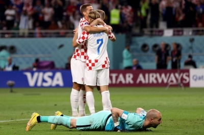 Croatia&#039;s midfielder Lovro Majer celebrates with teammates after scoring his team&#039;s fourth goal during the Qatar 2022 World Cup Group F football match at the Khalifa International Stadium in Doha.