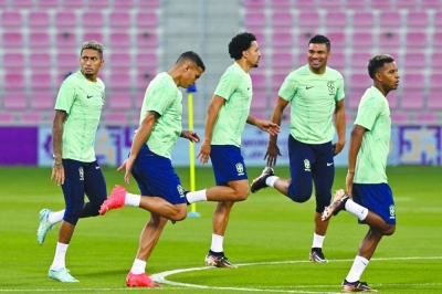 From left: Brazil’s forward  Raphinha, defenders Thiago Silva, Marquinhos and midfielder Casemiro attend a training session with teammates at the Al Arabi SC in Doha yesterday, on the eve of the Qatar 2022 World Cup match against Switzerland. (AFP)