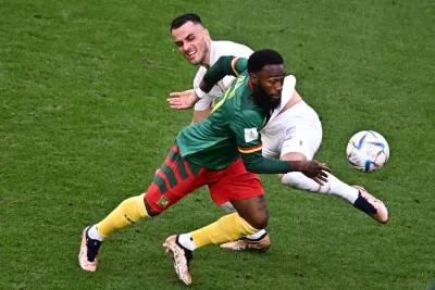 Cameroon&#039;s midfielder #07 Georges-Kevin Nkoudou (Front) fights for the ball with Serbia&#039;s midfielder #17 Filip Kostic during the Qatar 2022 World Cup Group G football match between Cameroon and Serbia at the Al-Janoub Stadium in Al-Wakra. 