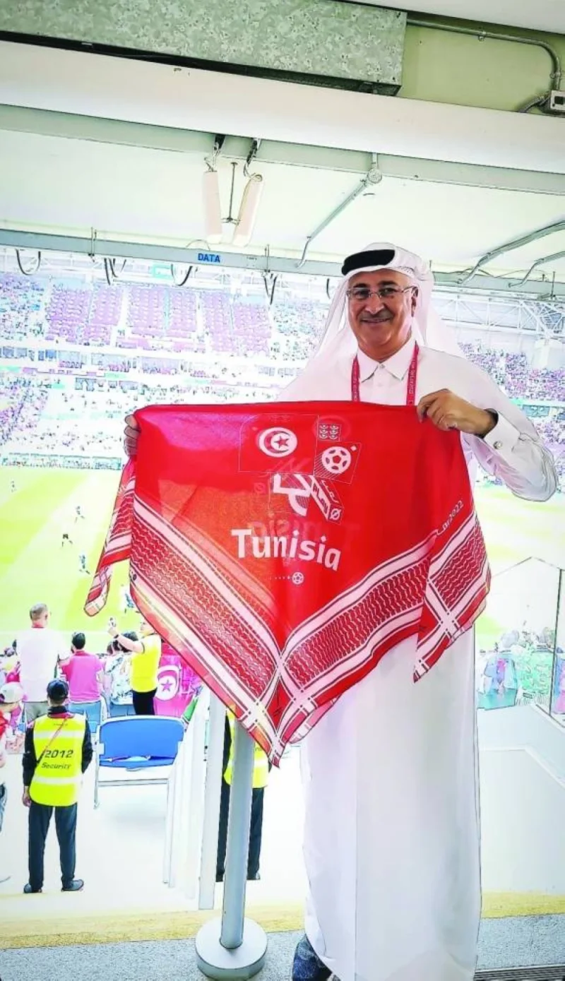 Ashraf Abu Issa holding a ghutra with Tunisian colours (supplied picture).