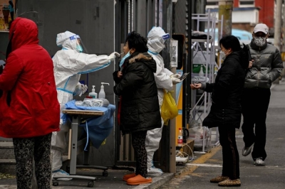 Residents undergo swab testing at a residential area under lockdown due to Covid-19 (AFP)