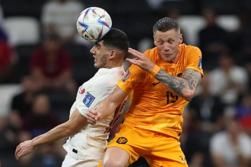 Qatar&#039;s midfielder #12 Karim Boudiaf (L) fights for the ball with Netherlands&#039; midfielder #15 Marten de Roon during the Qatar 2022 World Cup Group A match between the Netherlands and Qatar at the Al-Bayt Stadium in Al Khor. AFP