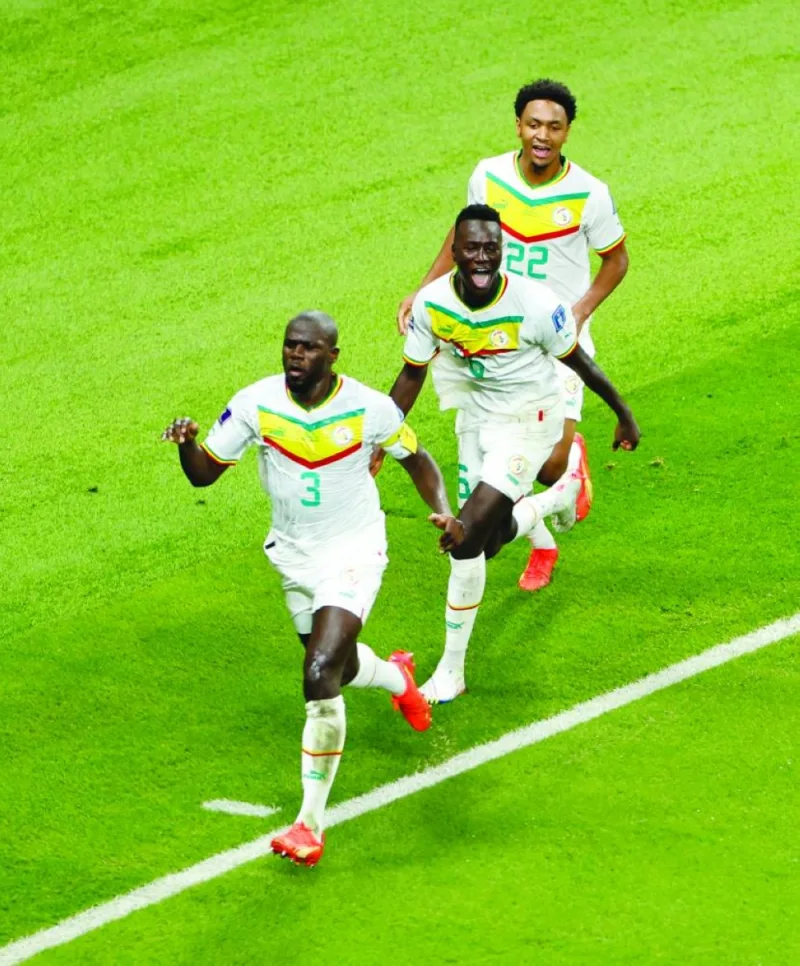 Senegal’s Kalidou Koulibaly (left) celebrates scoring their second goal against Ecuador with teammates at the Khalifa International Stadium in Doha yesterday. (Reuters)