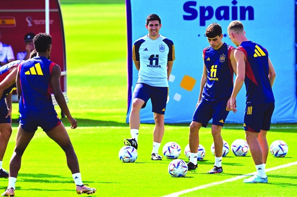 Spain's forward Dani Olmo (right) and midfielder Pedri (second right) take part in a training session at Qatar University training site in Doha on Monday.
