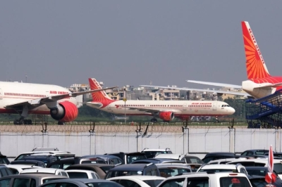 An Air India aircraft taxis past other aircraft operated by the airline at the Indira Gandhi International Airport in New Delhi. India’s aviation market may be moving towards a duopoly following the merger of two full-service carriers Air India and Vistara.