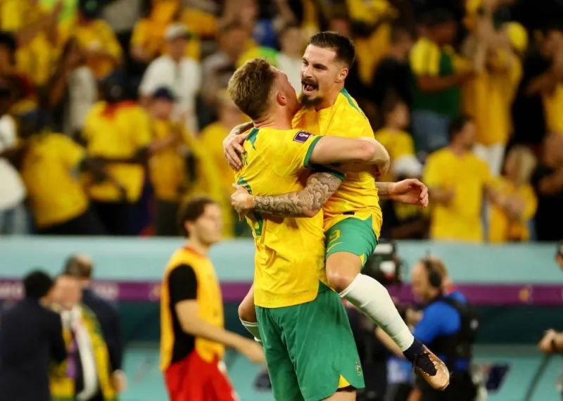 Australia&#039;s Harry Souttar and Jamie Maclaren celebrate qualifying for the knockout stages. REUTERS