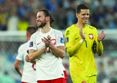 Poland’s Grzegorz Krychowiak and Wojciech Szczesny (right) celebrate after the match as they qualified for the knockout stages. (Reuters)