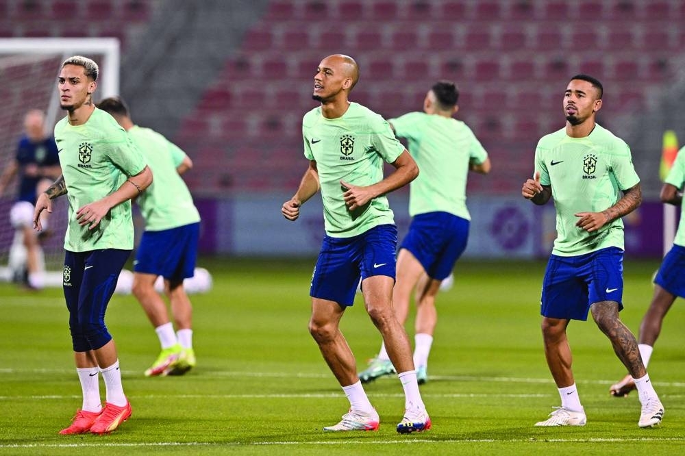 From left: Brazil&#039;s forward Antony, Brazil&#039;s midfielder Fabinho and Brazil&#039;s forward Gabriel Jesus take part in a training session at the Al Arabi SC Stadium in Doha on the eve of the Qatar 2022 World Cup match against Cameroon. 