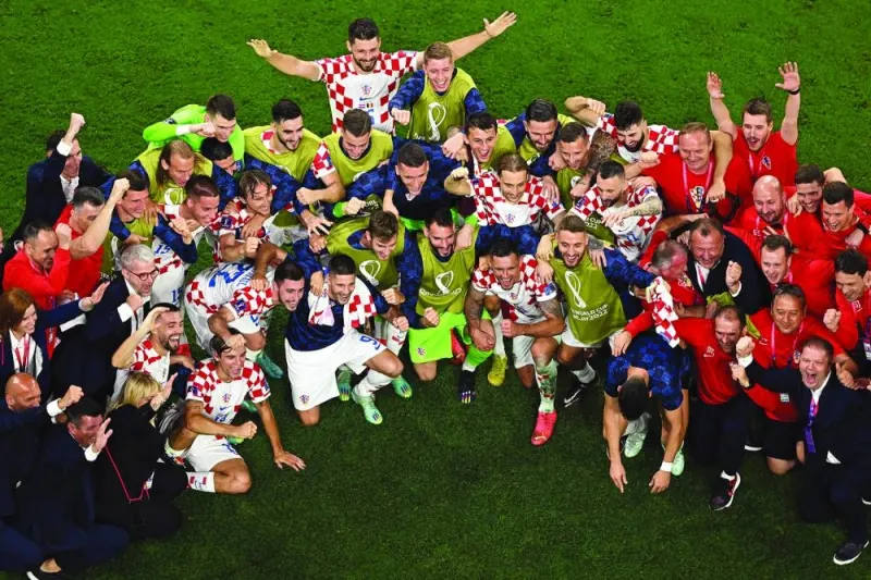 TOPSHOT - Croatia&#039;s players and team members celebrate at the end of the Qatar 2022 World Cup Group F football match between Croatia and Belgium at the Ahmad Bin Ali Stadium in Al-Rayyan, west of Doha on December 1, 2022. 
