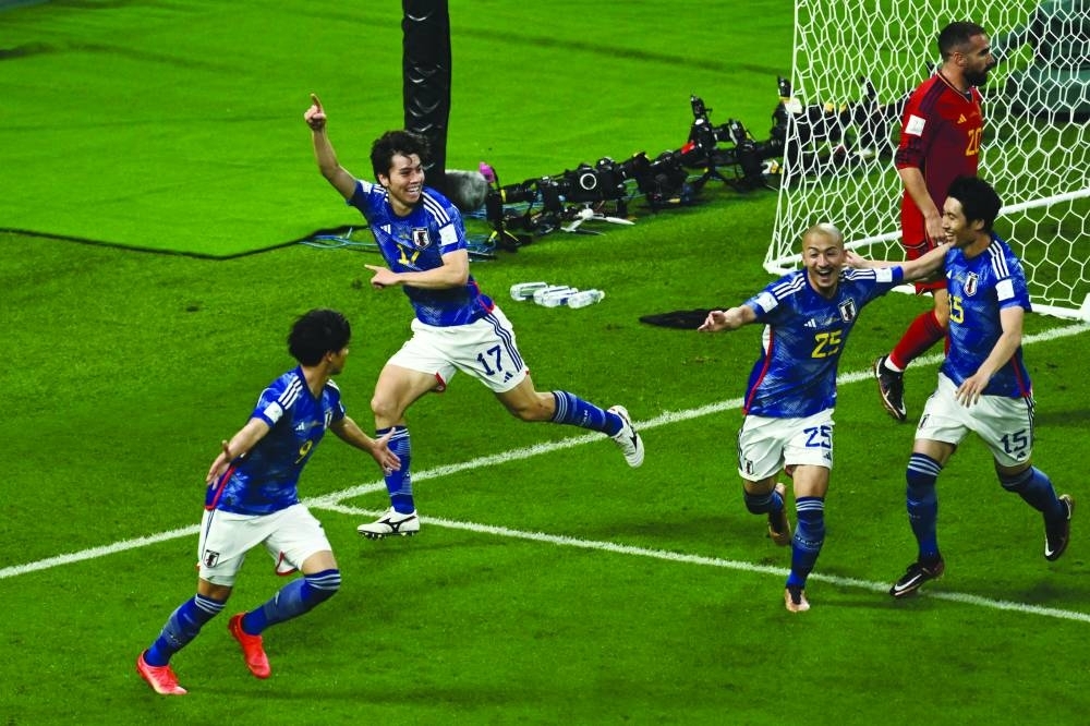 Japan’s midfielder Ao Tanaka (second from left) celebrates scoring a goal with his teammates during the Qatar 2022 World Cup Group E match against Spain at the Khalifa International Stadium in Doha yesterday. (AFP)