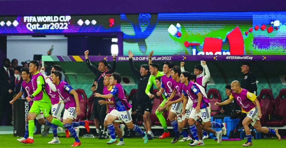 Japan&#039;s teammates celebrate after winning the Qatar 2022 World Cup Group E match against Spain at the Khalifa International Stadium in Doha yesterday. (AFP)