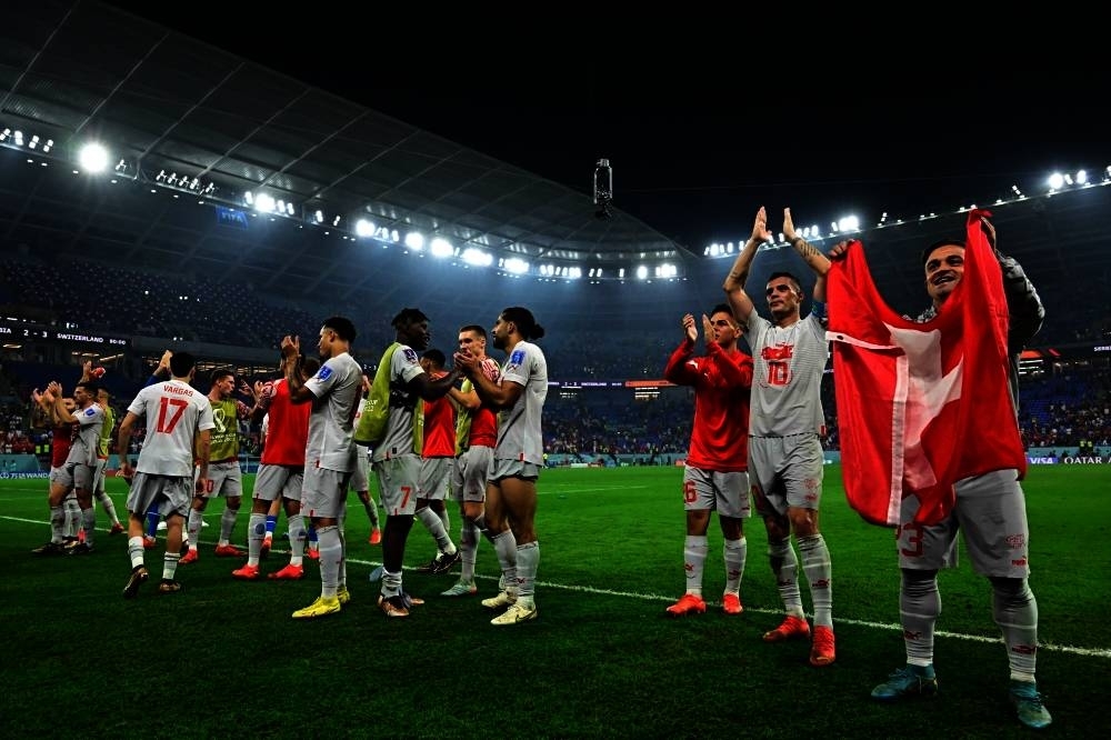 Players of Switzerland celebrate defeating Serbia 3-2 and qualifying to the next round of the tournament, at the end of the Qatar 2022 World Cup Group G football match between Serbia and Switzerland at Stadium 974 in Doha.
