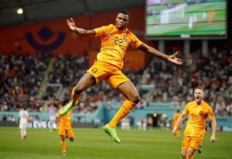 The Netherlands&#039; Denzel Dumfries celebrates scoring their third goal against the US.