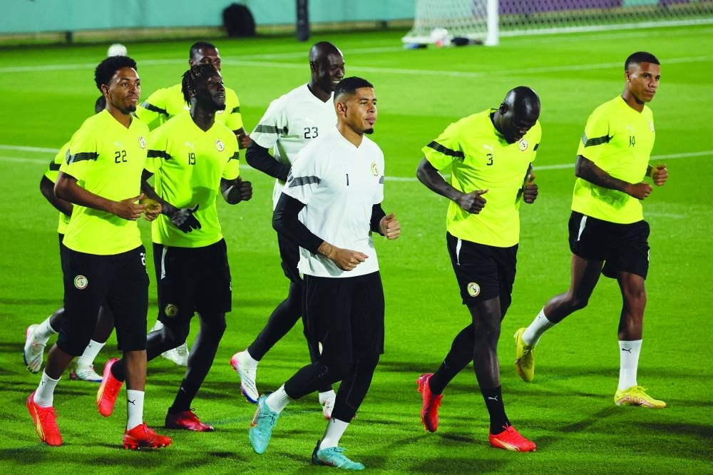 Senegal's players take part in a training session at Al Duhail SC in Doha yesterday on the eve of the Qatar 2022 World Cup match against England. (AFP)