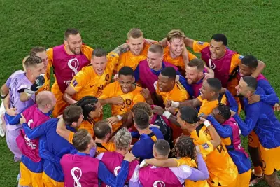 Netherlands players celebrate after qualifying for the Qatar 2022 quarter-finals at Khalifa International Stadium in Doha yesterday. (AFP)