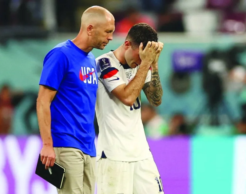 Christian Pulisic of the US looks dejected alongside coach Gregg Berhalter after the match as the United States are eliminated from the World Cup yesterday. (Reuters)