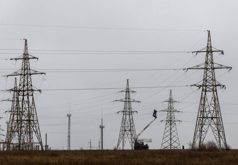 FILE PHOTO: Electric power lines damaged by Russian military strikes (Reuters)