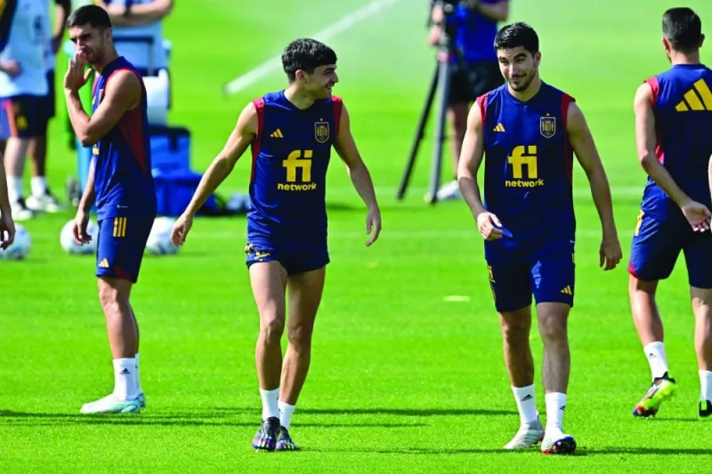 Spain’s midfielder Carlos Soler (right) and Pedri attend a training session at the base camp of Qatar University in Doha yesterday. (AFP)