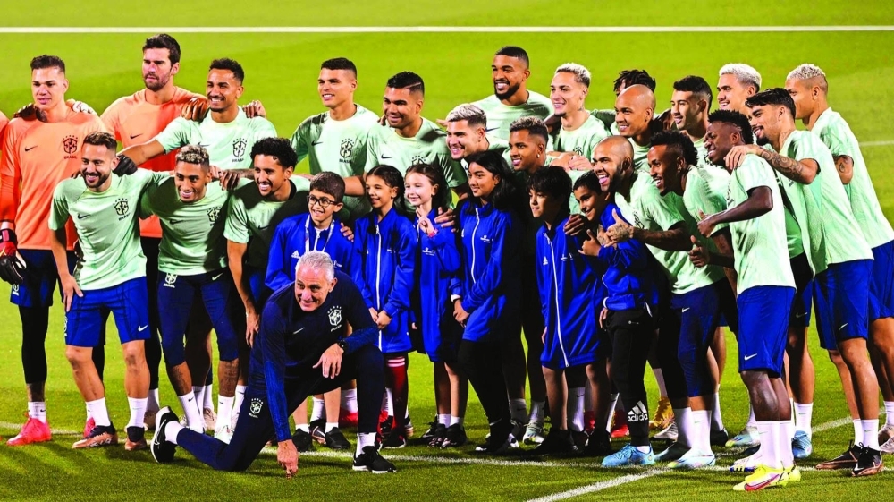 Brazil’s players pose with kids during a training session at the Al Arabi SC Stadium in Doha yesterday, on the eve of the Qatar 2022 World Cup match against South Korea. (AFP)