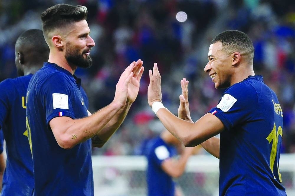 France&#039;s forward Kylian Mbappe (right) celebrates their win with teammate Olivier Giroud  yesterday. (AFP)