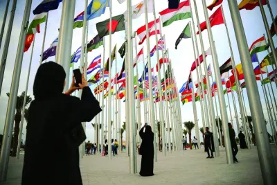 Women take photos at the Flag Plaza in Doha. Qatar&#039;s economy is now the largest it has ever been following the 6.3% year-on-year (y-o-y) surge in output in Q2. Data show the expansion was driven by 9.7% y-o-y growth in the non-oil sectors, up from 5% in Q1, amid strength in construction, transportation, wholesale and retail trade, and real estate. 