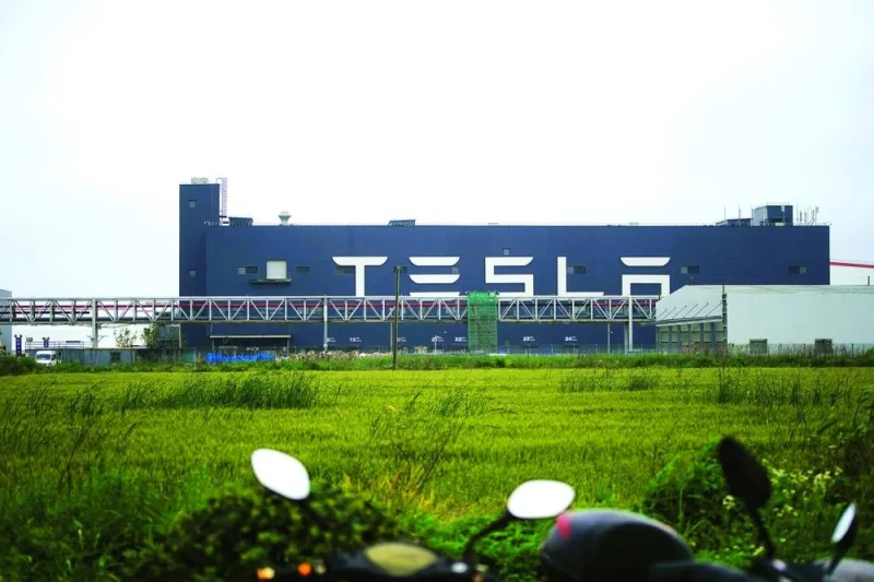 A Tesla sign is seen at its factory in Shanghai. Tesla plans to lower production at its Shanghai factory, according to people familiar with the matter, in the latest sign demand in China isn’t meeting expectations.