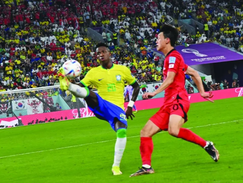Brazil’s Vinicius Junior (left) vying for the ball with a Japan player at Stadium 974 yesterday. PICTURE: Shaji Kayamkulam