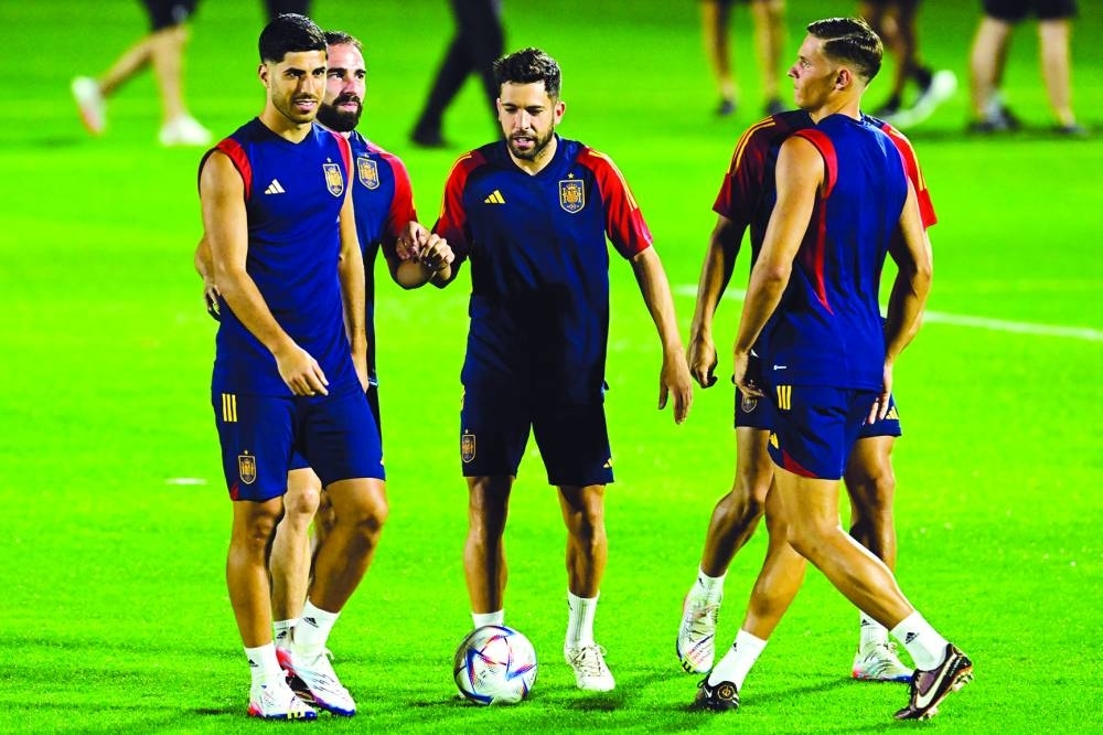From left: Spain’s forward Marco Asensio, defender Dani Carvajal, defender Jordi Alba and midfielder Marcos Llorente attend a training session at Qatar University in Doha. (AFP)