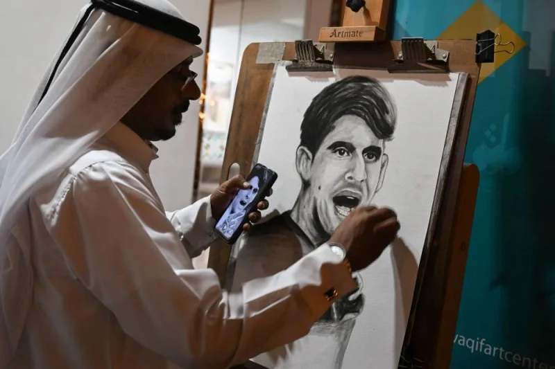 An artist paints a portrait of Morocco&#039;s goalkeeper Yassine Bounou in Doha Tuesday after their team won the Qatar 2022 World Cup round of 16 football match between Morocco and Spain.