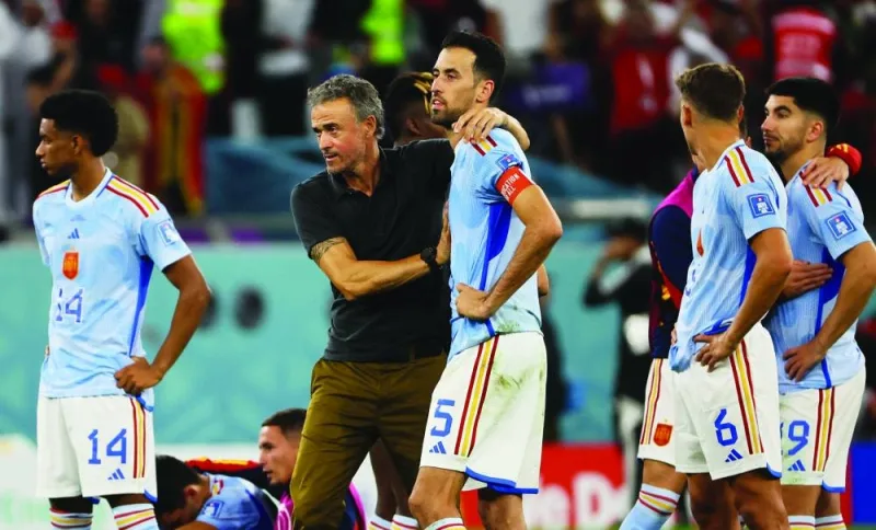 Spain coach Luis Enrique (left) with Sergio Busquets as their team is eliminated from the World Cup yesterday. (Reuters)