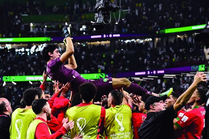 MoroccoMorocco players throw goalkeeper Yassine Bounou in the air as they celebrates winning the Qatar 2022 World Cup Round of 16 match against Spain at the Education City Stadium in Al Rayyan yesterday. (AFP)