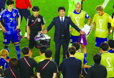 Japan coach Hajime Moriyasu speaks to his players after the round of 16 match against Croatia at the Al Janoub Stadium, Al Wakra, on Monday. (Reuters)