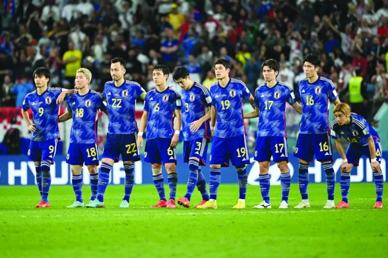 Japan’s players stand together at the start of the penalty shootout during the Qatar 2022 World Cup round of 16 football match against Croatia at the Al Janoub Stadium in Al Wakra on Monday. (AFP)