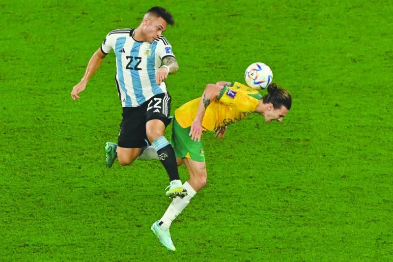 Argentina's forward Lautaro Martinez (22) fights for the ball with Australia's midfielder Jackson Irvine during the Qatar 2022 World Cup Round of 16 match at the Ahmad Bin Ali Stadium in Al-Rayyan, west of Doha, yesterday. (AFP)
