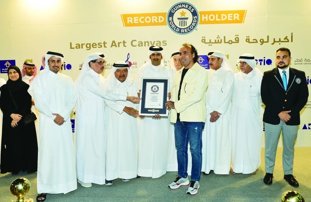 HE the Minister of Culture Sheikh Abdulrahman bin Hamad al-Thani, HE Sheikh Faisal bin Qassim al-Thani, HE the Minister of State and Qatar National Library president Hamad bin Abdulaziz al-Kawari and artist Imad Salehi with the citation from Guinness World Records.