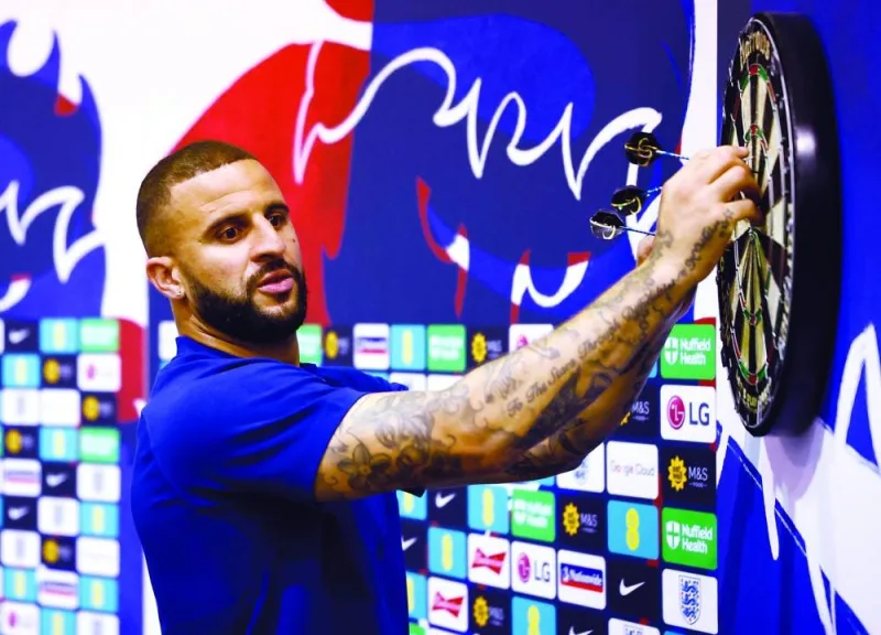 England’s defender Kyle Walker plays darts at the Al Wakrah SC Stadium yesterday. England and France will meet in one of the Qatar 2022 World Cup quarter-finals on December 10. (Reuters)