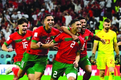 Morocco's defender Achraf Hakimi (second from right) celebrates with teammates after converting the last penalty during the penalty shoot-out to win the Qatar 2022 World Cup Round of 16 match against Spain at the Education City Stadium in Al Rayyan on Tuesday. (AFP)