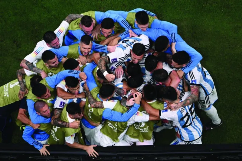 Argentina players celebrate after Lionel Messi scored his team’s second goal from the penalty spot. (AFP)