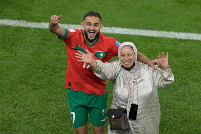 Morocco&#039;s Sofiane Boufal celebrates with his mother after defeating Portugal.